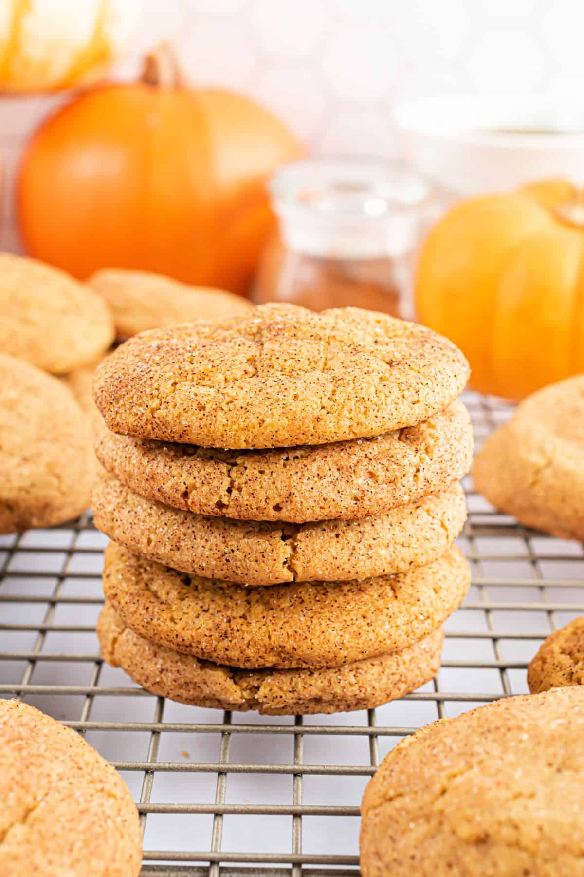Stack of five pumpkin snickerdoodles on a wire cooling rack.