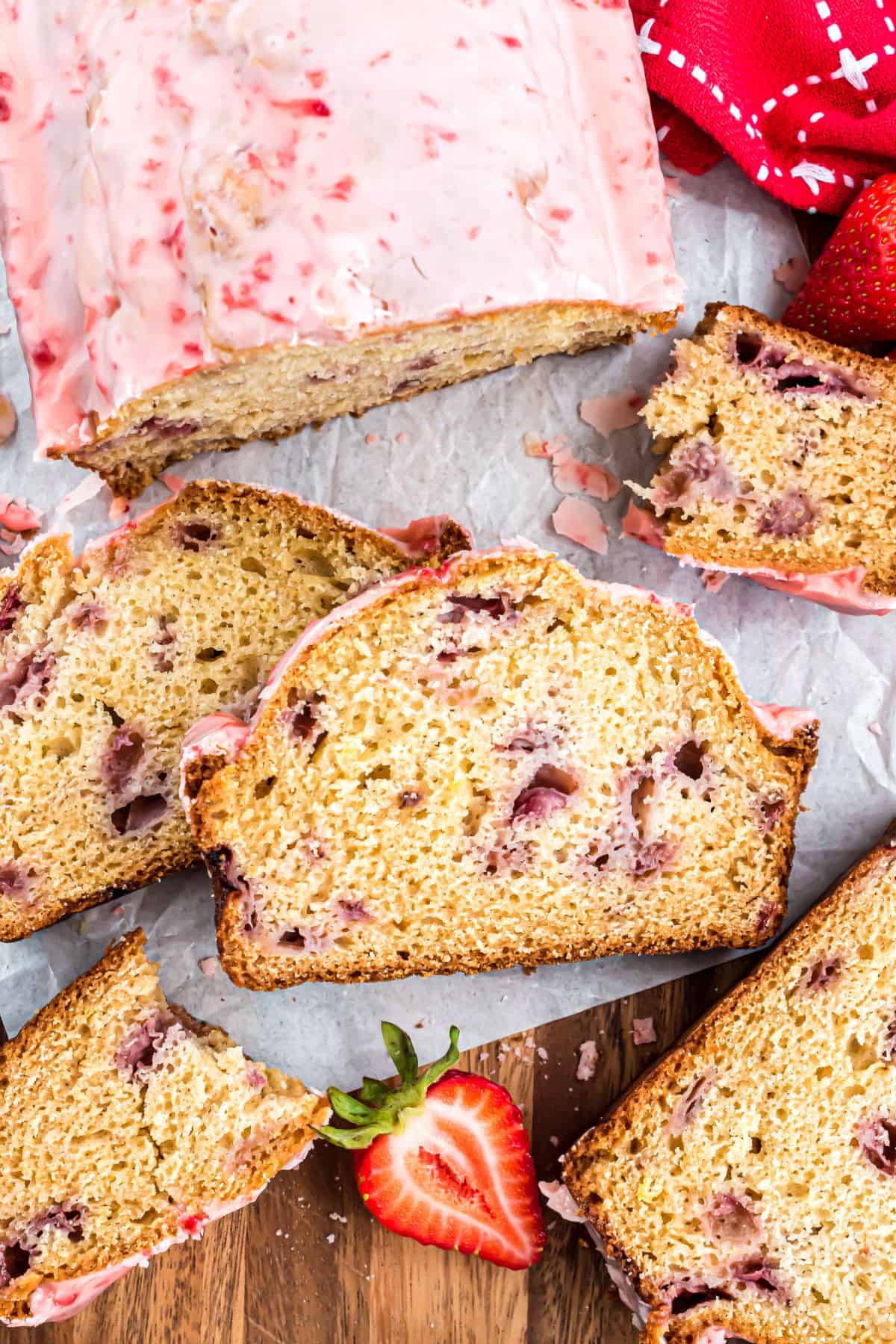 Slices of strawberry bread with strawberry icing.