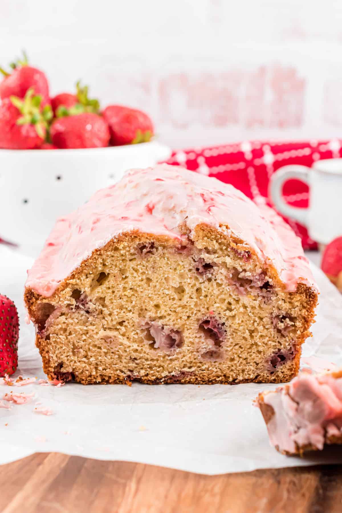 Loaf of strawberry bread with a slice removed showing the inside.