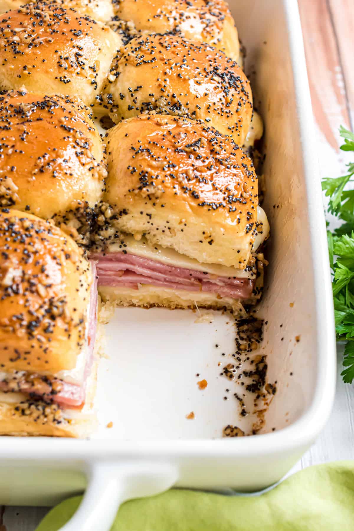 Ham and cheese sliders made in a white 13x9 dish.