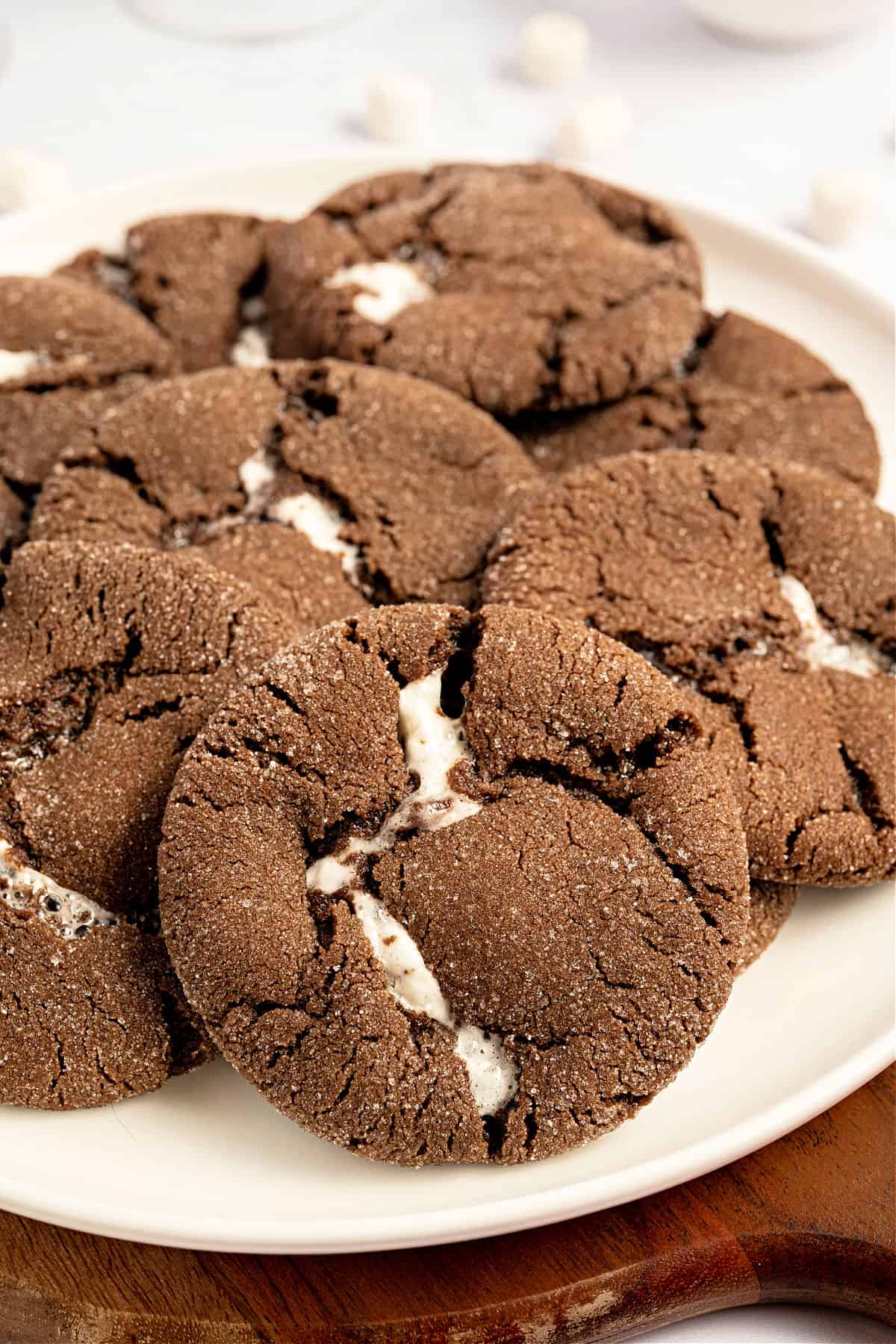 Marshmallow sutffed chocolate cookies on a white plate.