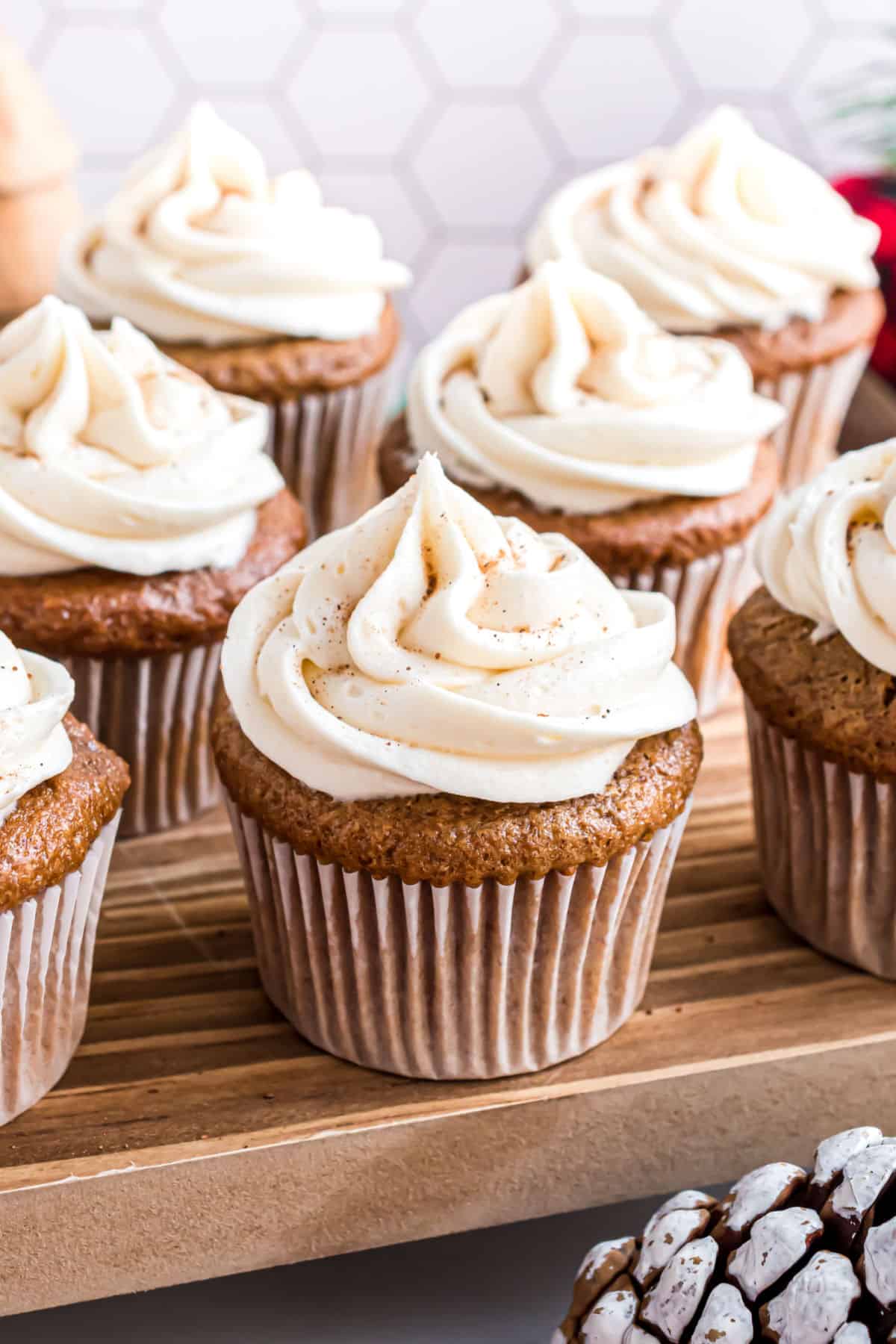 Gingerbread cupcakes on a wooden serving board.