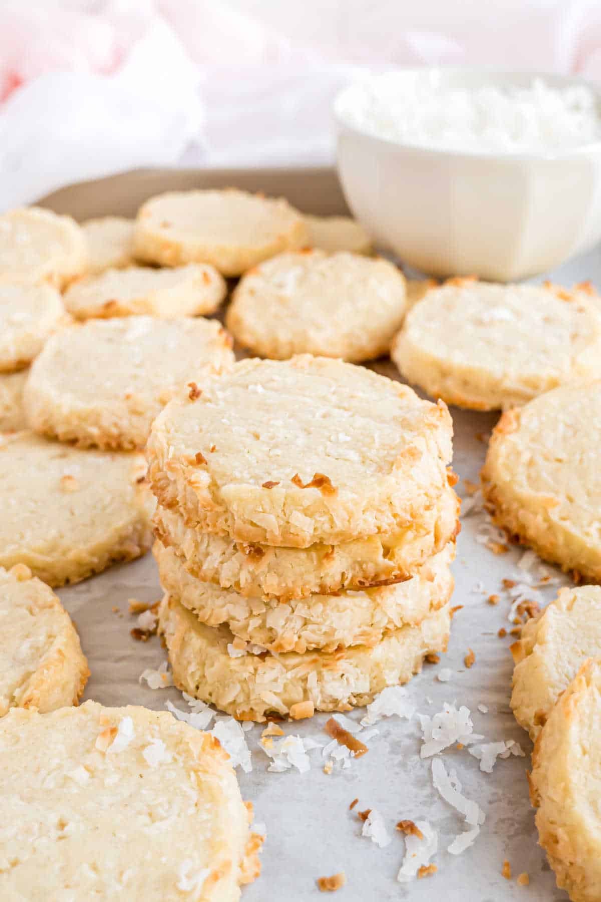 Shortbread cookies with coconut stacked on top of each other.