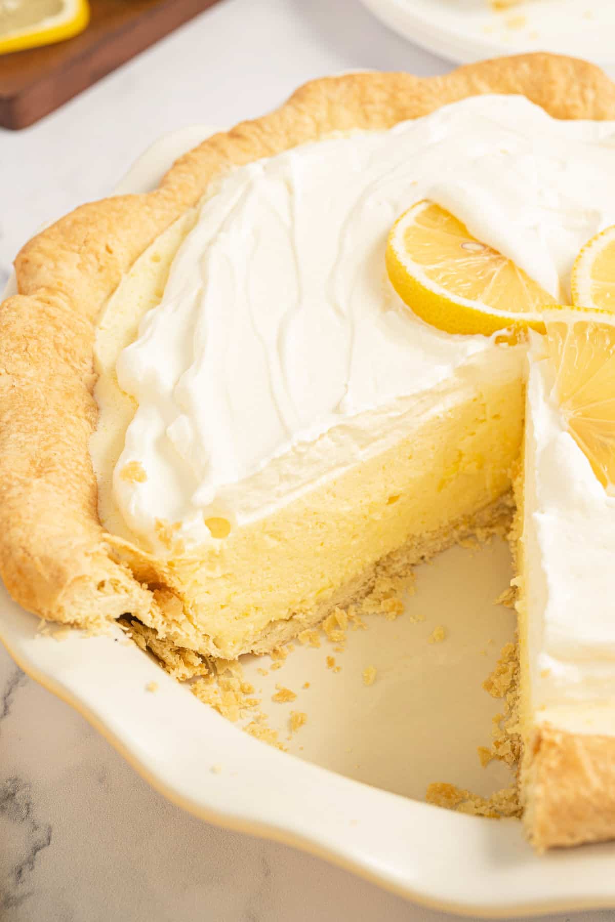 Lemon chiffon pie with a slice removed.