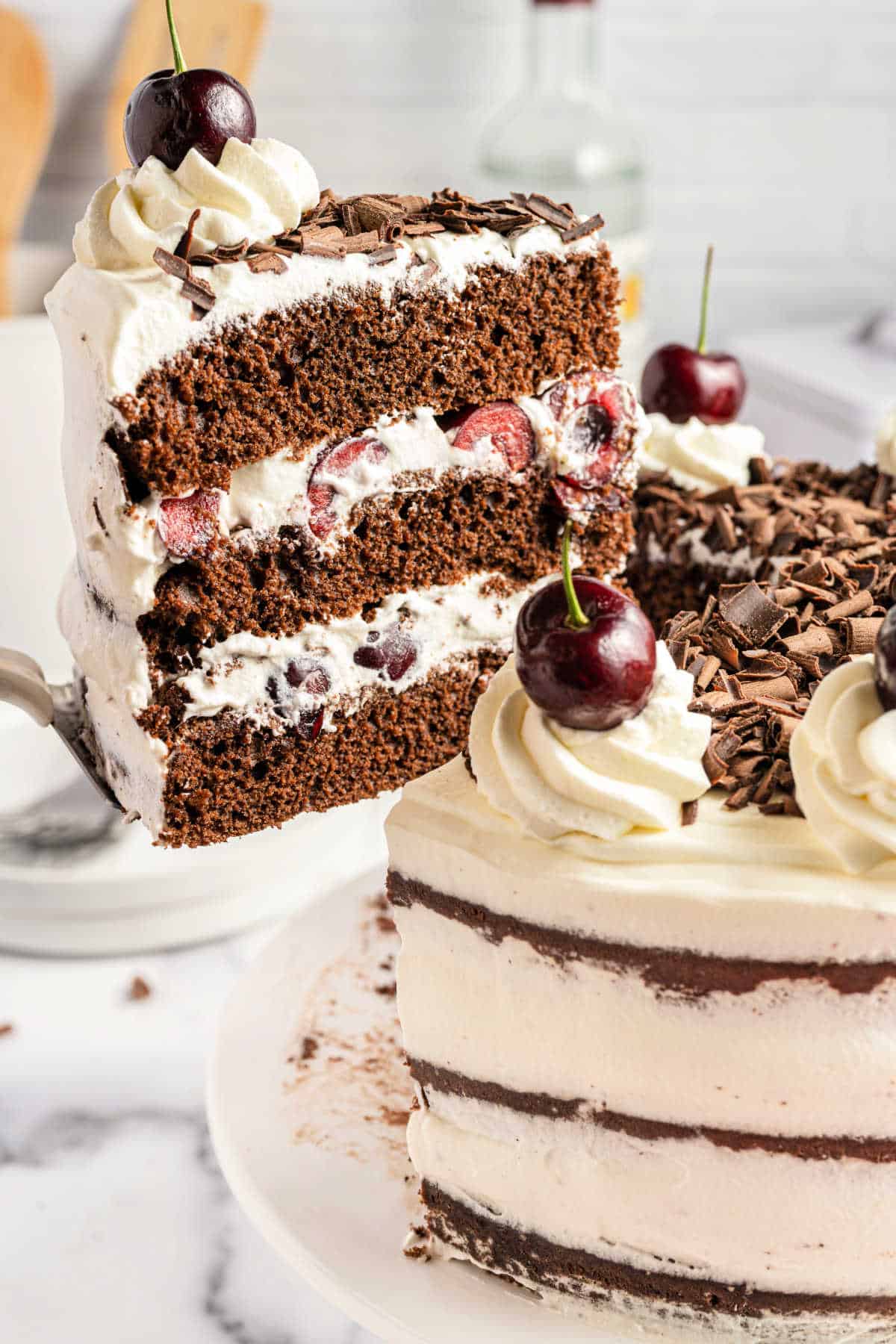 Slice of cake being lifted off cake platter.