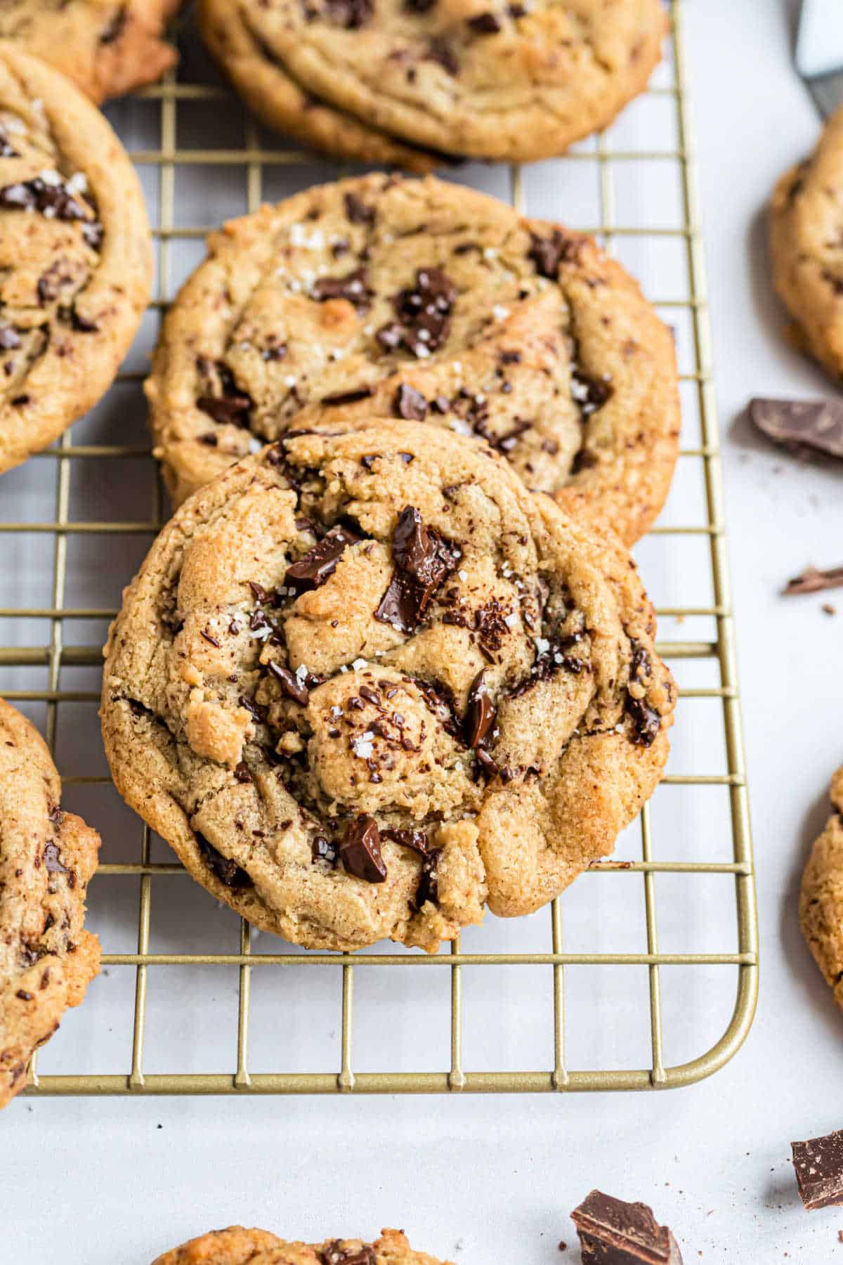 Brown butter chocolate chip cookies on a wire cooling rack.