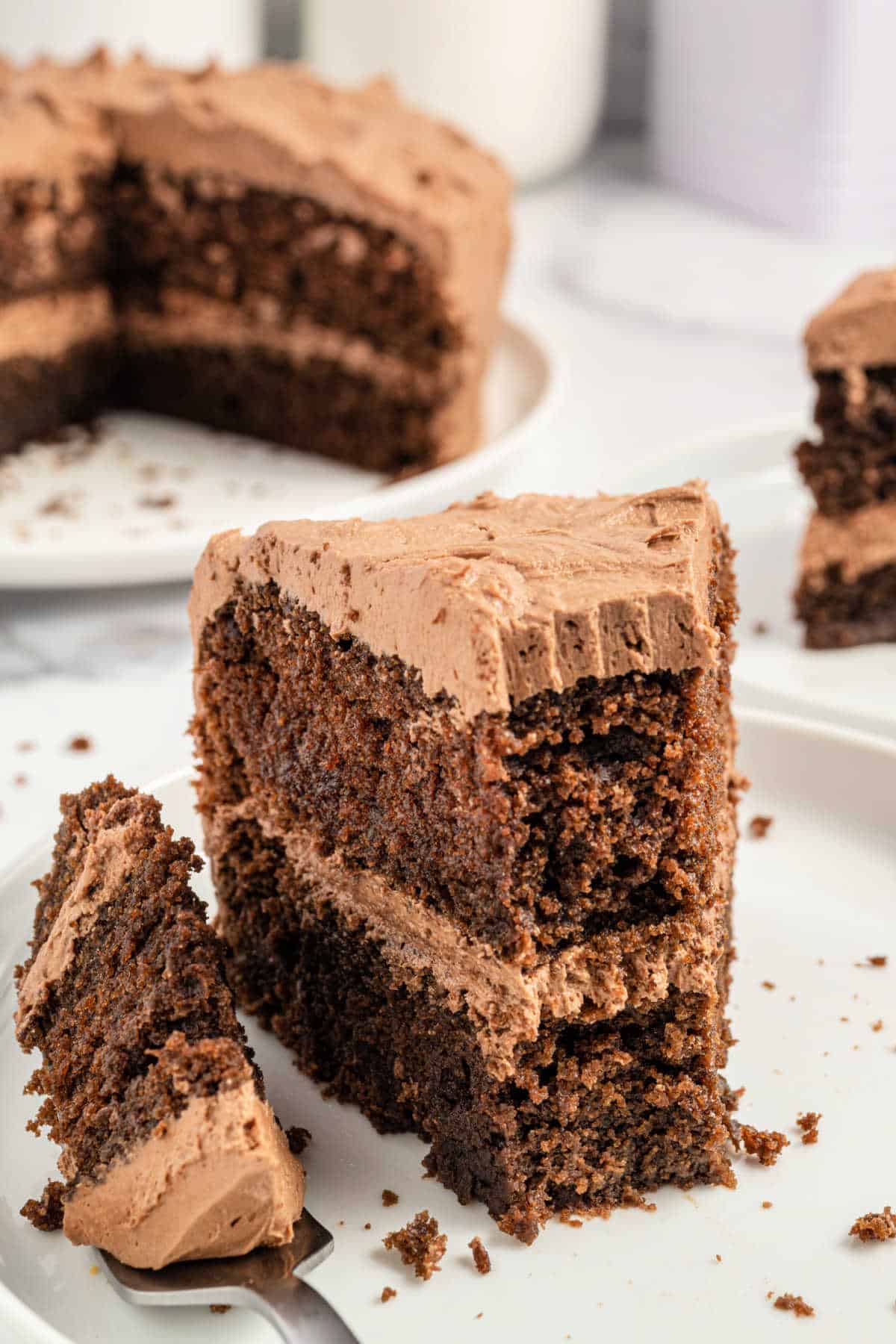 Slice of chocolate mayonnaise cake with a bite taken out.