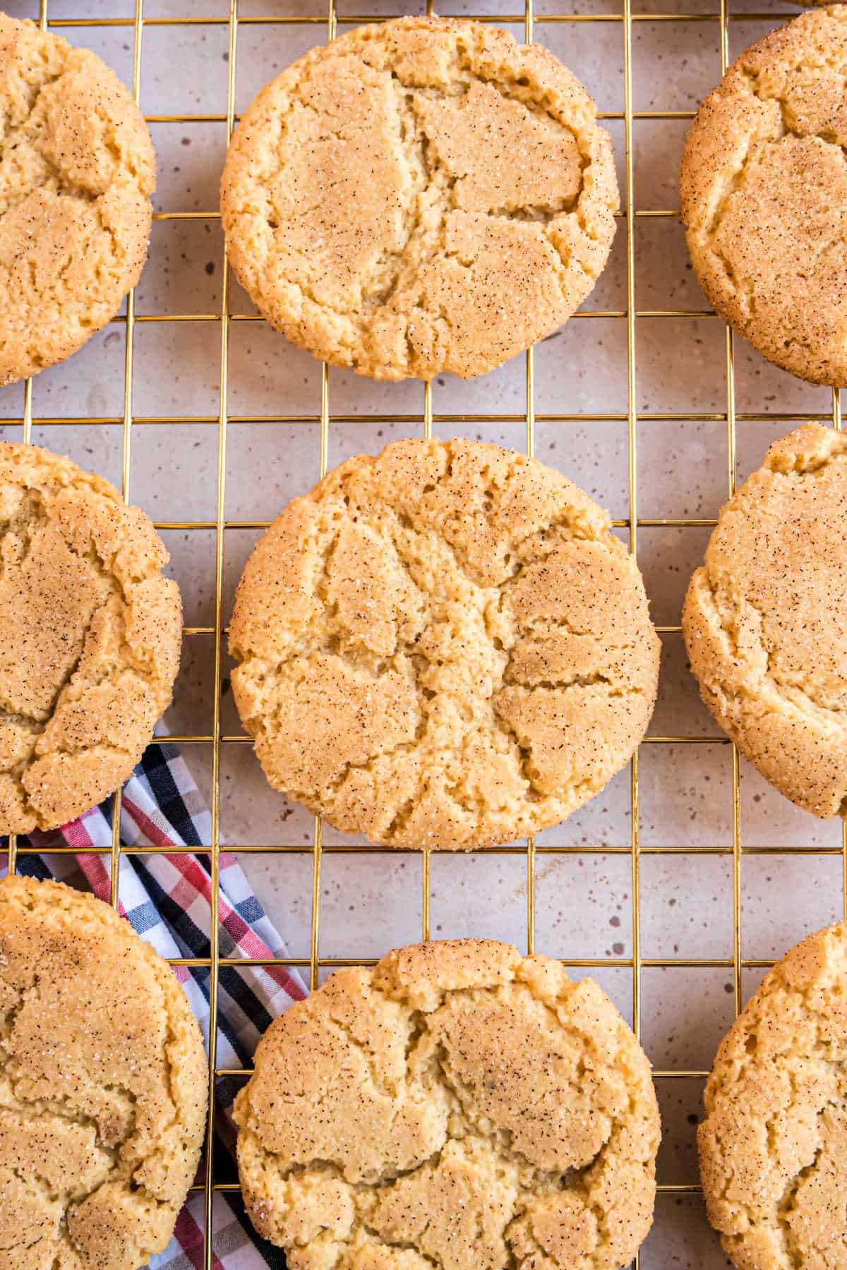 Snickerdoodle cookies cooling on a wire rack.