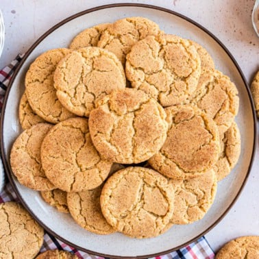 Cookies stacked on a large white platter.