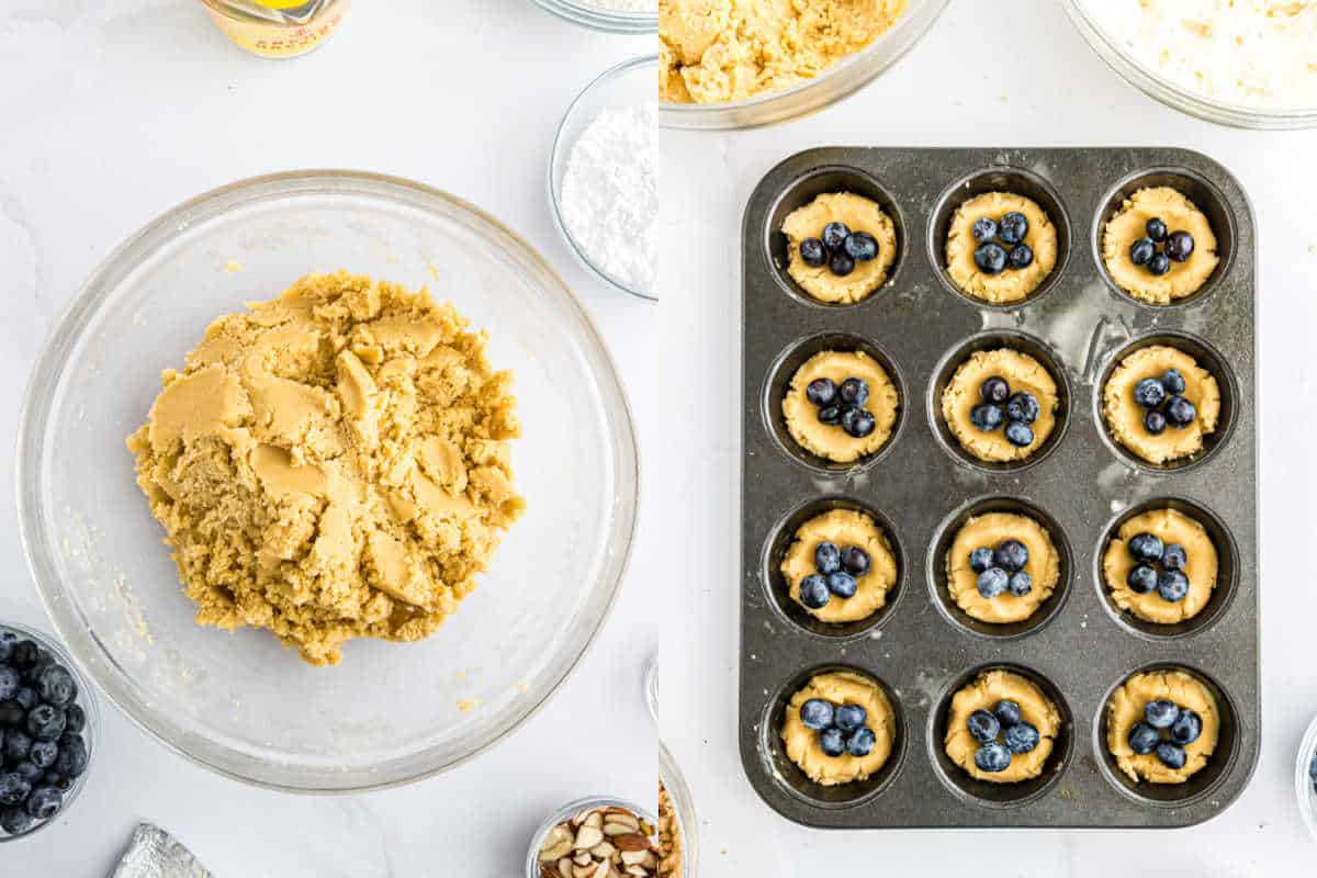 Cookie dough in a glass bowl, and muffin tin with blueberry coffee cake cookies dough cups filled with blueberries, on a white surface.