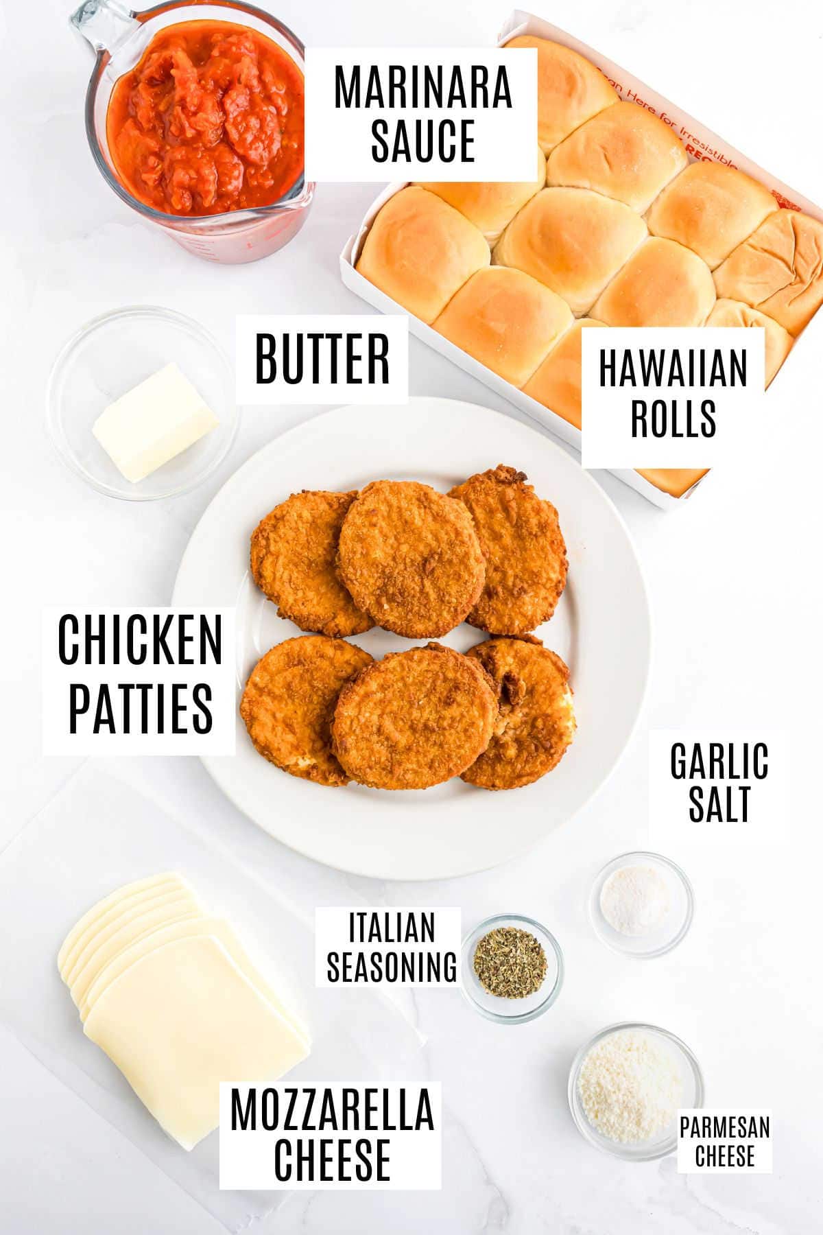 Top view of ingredients: Hawaiian rolls, marinara, chicken patties, mozzarella, butter, Italian seasoning, garlic salt.