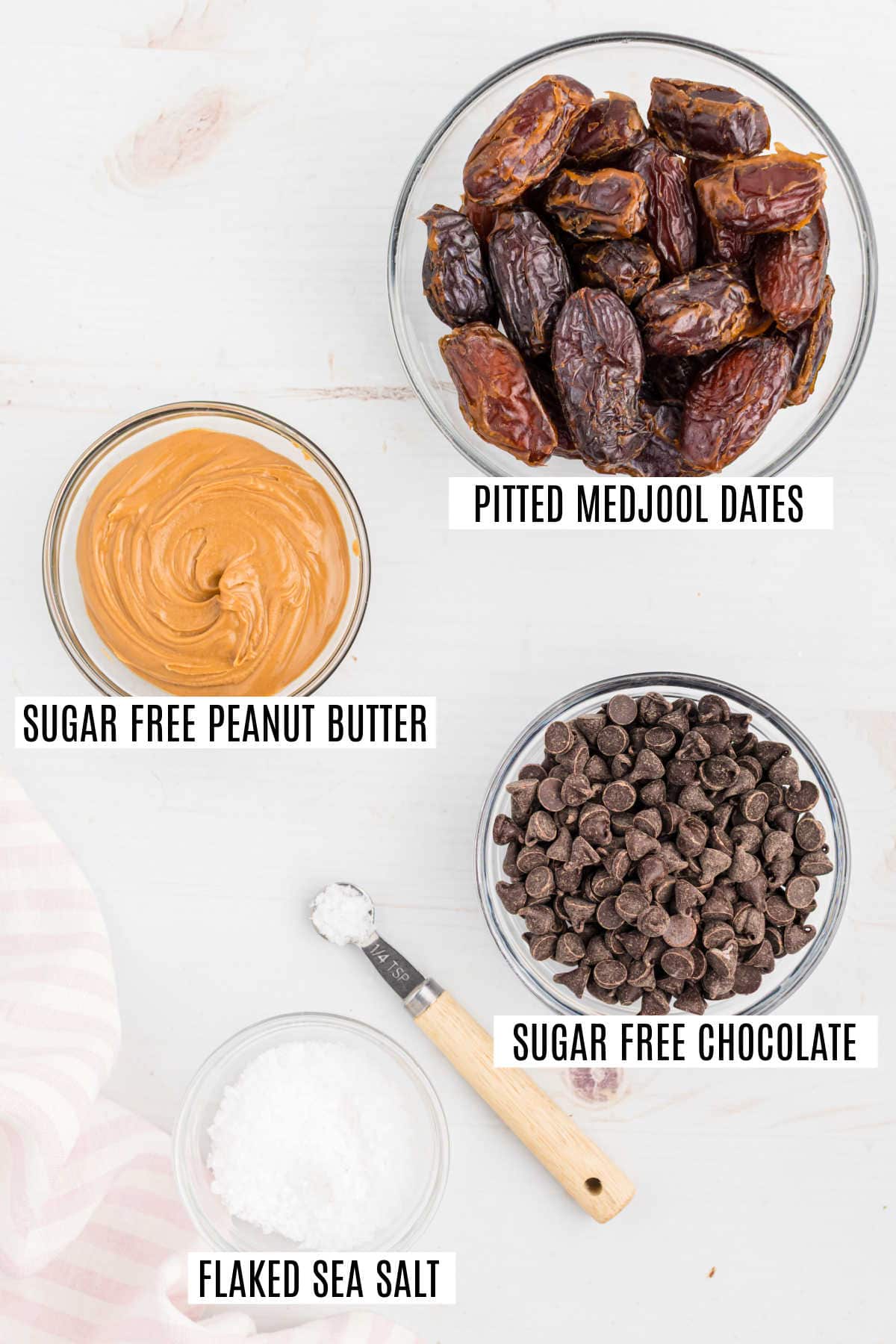 Four bowls with pitted Medjool dates, sugar-free peanut butter, sugar-free chocolate, and flaked sea salt.