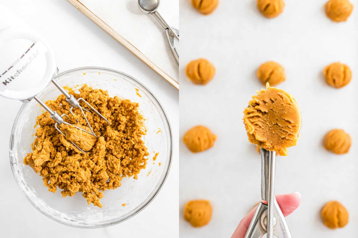 A bowl of cookie dough with a mixer and scoops of dough on a baking sheet, ready to bake.