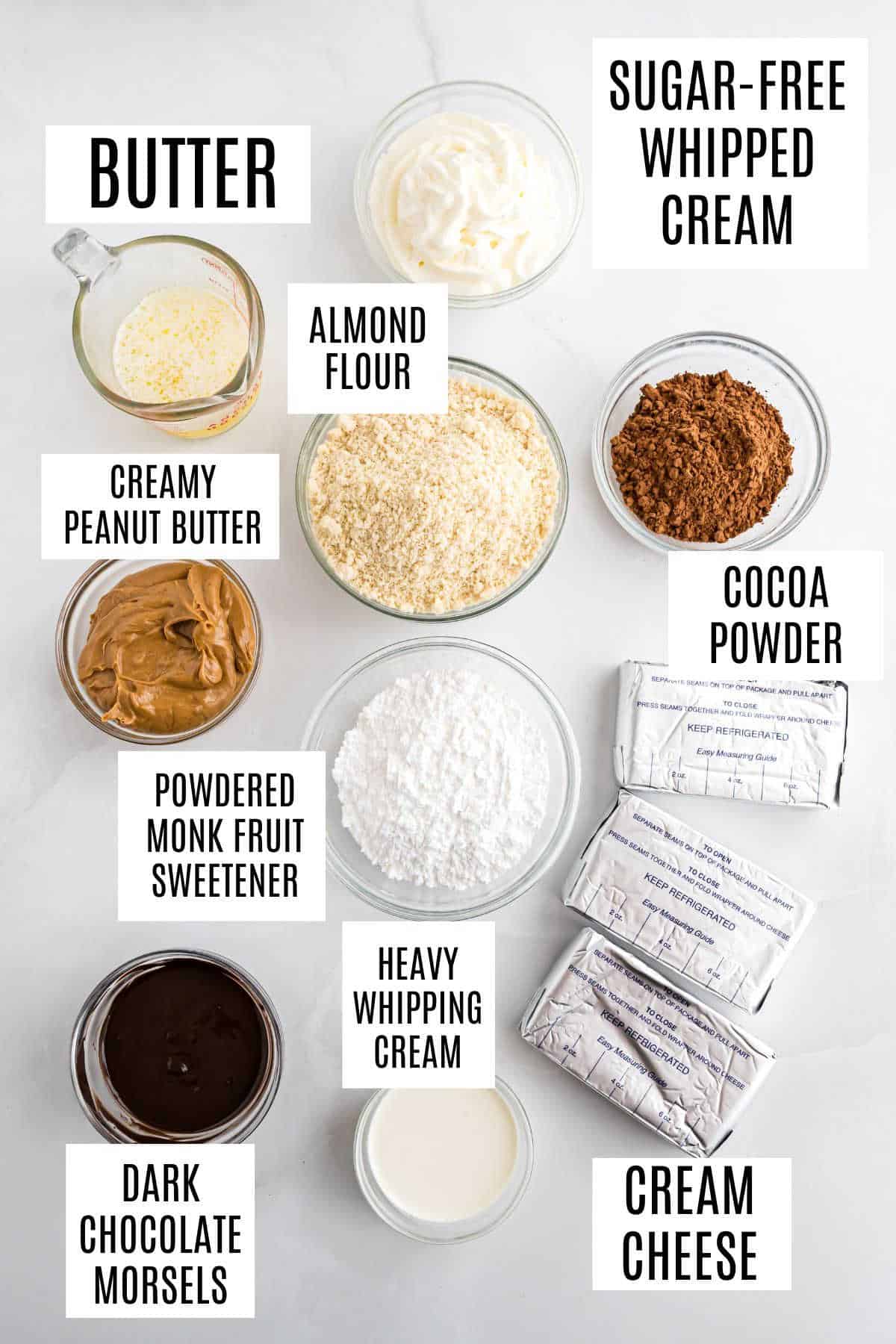 Ingredients for a dessert recipe, including butter, cream cheese, cocoa powder, almond flour, and sweeteners.