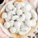 Snowball cookies on white plate.