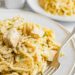 Chicken tetrazzini scooped onto a white dinner plate with silver fork.