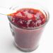 Strawberry jam in a clear glass jar.